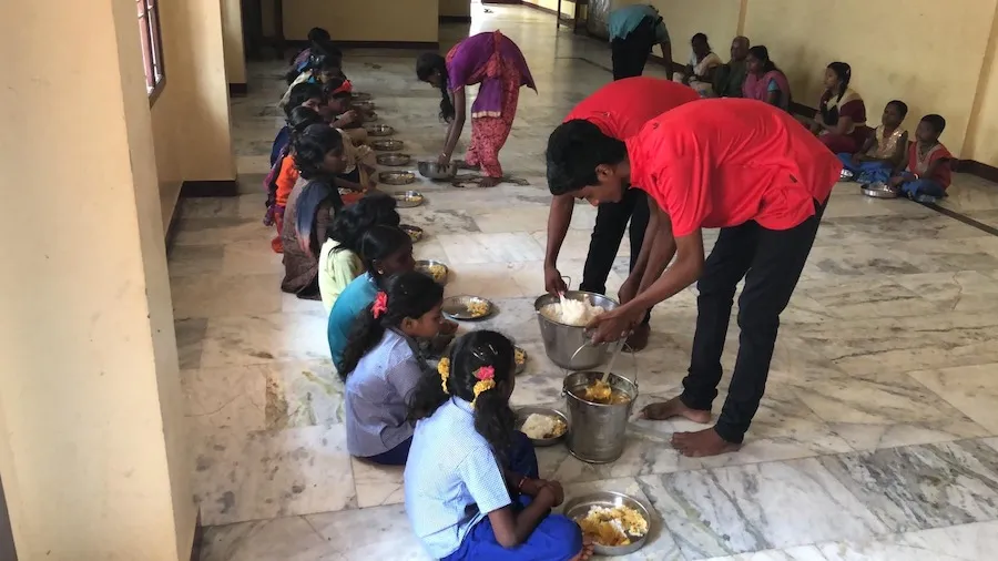 Vortex staff sharing food to children in India