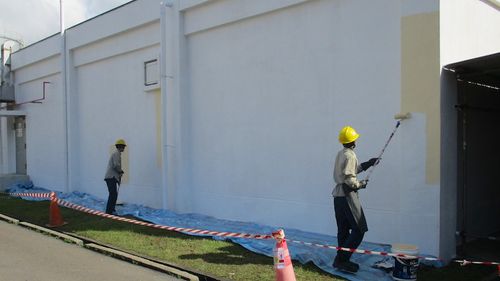 Vortex staff painting a building exterior