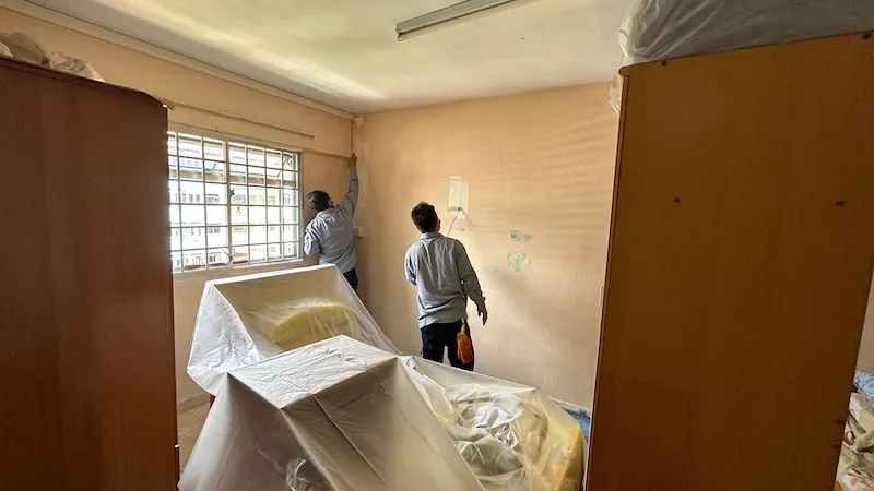 Vortex staff painting a room